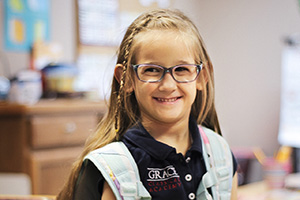 Grace Classical Academy student smiling at the camera.